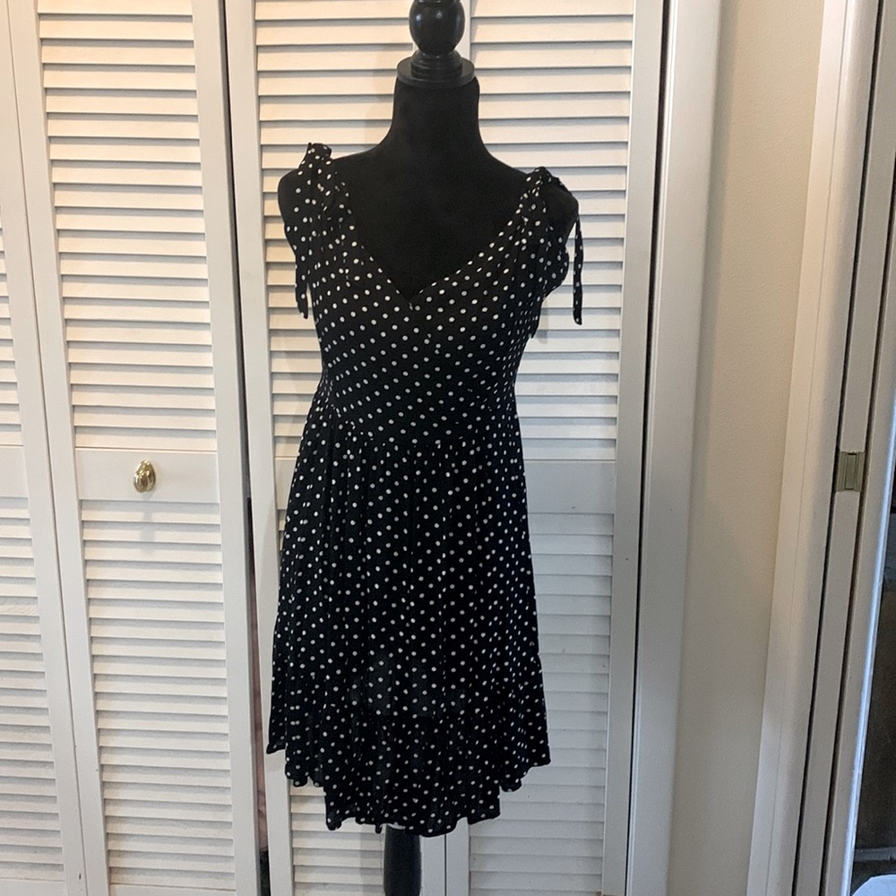Flirty black polka dot tie strap mini dress .